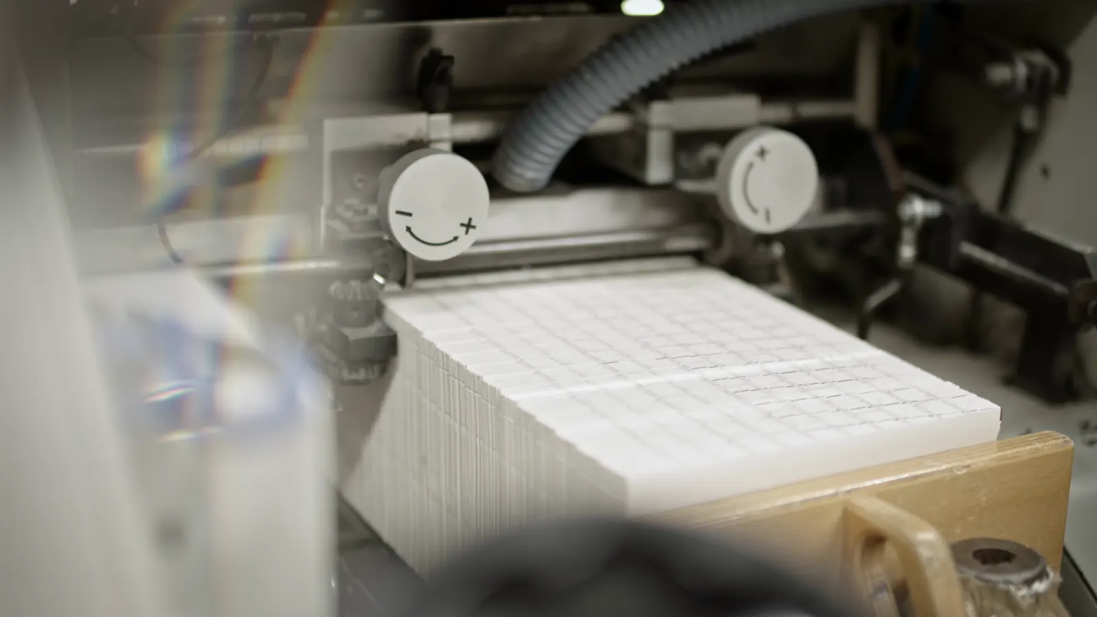 Printed sheets moving through a press.